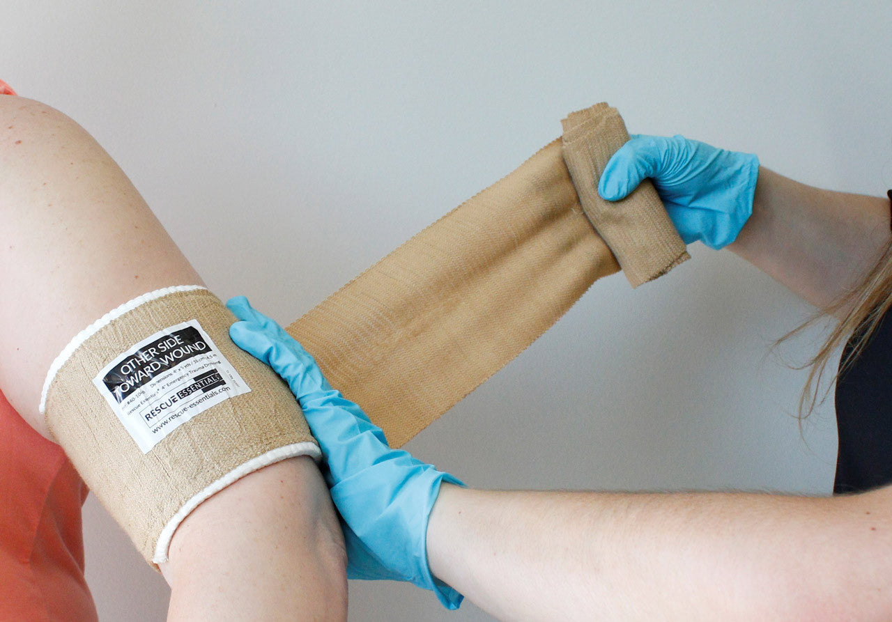Rescue Essentials Emergency Trauma Dressing, in use on arm