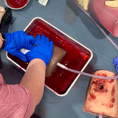 Dark Tone TrueClot® Wound Packing Task Trainer, In use
