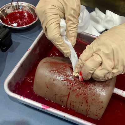 Dark Tone TrueClot® Wound Packing Task Trainer, In use
