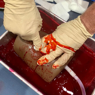 Dark Tone TrueClot® Wound Packing Task Trainer, In use