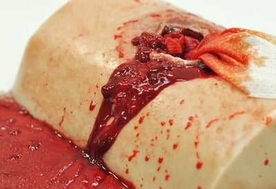 Blood Simulant Concentrate, 1 Gallon + Bottle by TrueClot in use for gunshot wound