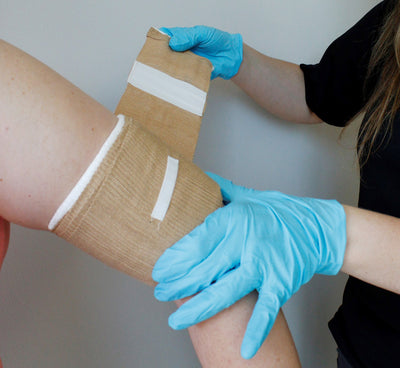 Rescue Essentials Emergency Trauma Dressing, in use on arm